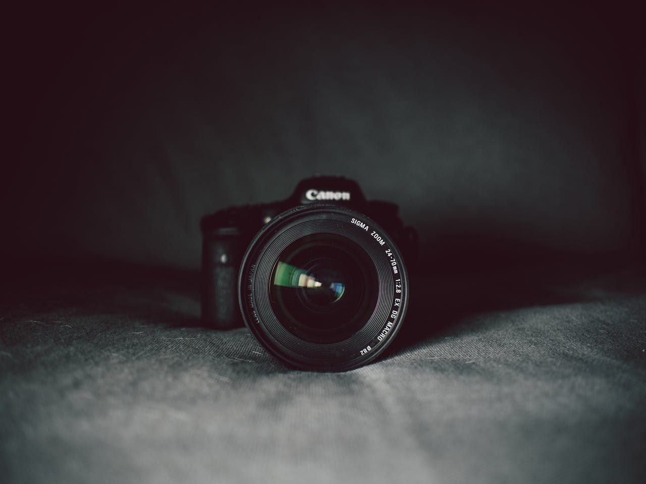 About A camera lens in focus against a dark background, highlighting the optical details.